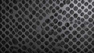 The primary subject of the image is a pattern of holes, which are arranged in a circular or hexagonal shape. The setting is a black background, which contrasts with the holes, creating a visually striking pattern. The visual style of the image is a close-up of the pattern, emphasizing the details of the holes. The colors and mood of the image are predominantly black, giving it a bold and striking appearance.