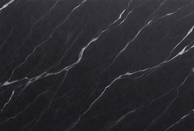 The primary subject of the image is a black marble countertop. The setting is a kitchen, with the countertop being the main focus of the scene. The visual style is a close-up of the marble countertop, showcasing its texture and pattern. The colors and mood of the image are predominantly dark, with the black marble countertop being the main source of contrast.