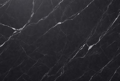 The primary subject of the image is a marble countertop with a black background. The countertop features a pattern of white and black veins, giving it a unique and elegant appearance. The visual style of the image is a close-up of the marble countertop, showcasing its intricate details. The colors and mood of the image are predominantly black and white, creating a sophisticated and timeless atmosphere.