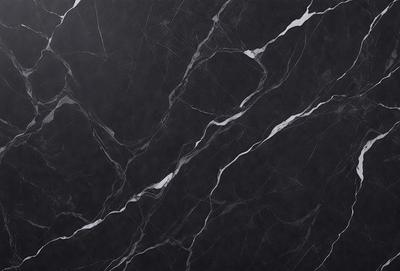 The primary subject of the image is a black marble countertop. The setting is a kitchen, with the countertop being the main focus of the scene. The visual style is a close-up of the marble countertop, showcasing its texture and pattern. The colors and mood of the image are predominantly dark, with the black marble countertop being the main source of contrast.