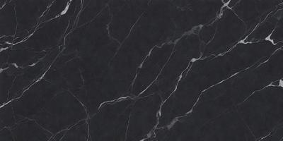 The primary subject of the image is a black marble countertop. The setting is a kitchen, with the countertop being the main focus of the scene. The visual style is a close-up of the marble countertop, showcasing its texture and pattern. The colors and mood of the image are predominantly dark, with the black marble providing a striking contrast against the darker background.