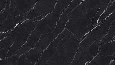 The primary subject of the image is a black marble countertop. The setting is a kitchen, with the countertop being the main focus of the scene. The visual style is a close-up of the marble countertop, showcasing its texture and pattern. The colors and mood of the image are predominantly dark, with the black marble providing a striking contrast against the surrounding environment.