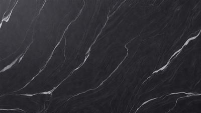 The primary subject of the image is a black marble countertop. The setting is a kitchen, with the countertop being the main focus of the scene. The visual style is a close-up of the marble countertop, showcasing its texture and pattern. The colors and mood of the image are predominantly dark, with the black marble providing a striking contrast against the dark background.