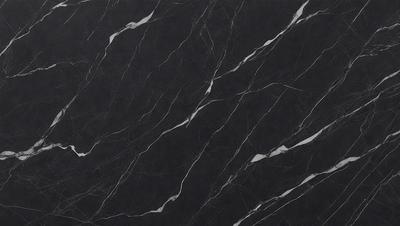 The primary subject of the image is a black marble countertop. The setting is a kitchen, with the countertop being the main focus of the scene. The visual style is a close-up of the marble countertop, showcasing its texture and pattern. The colors and mood of the image are predominantly black, giving it a sleek and modern appearance.