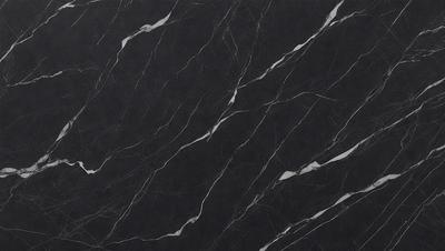 The primary subject of the image is a black marble countertop. The setting is a kitchen, with the countertop being the main focus of the scene. The visual style is a close-up of the marble countertop, showcasing its texture and pattern. The colors and mood of the image are predominantly dark, with the black marble countertop being the main source of contrast.