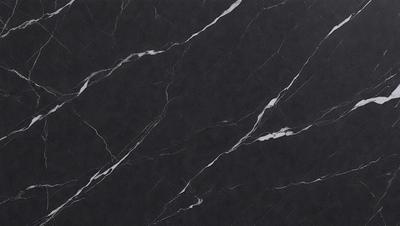 The primary subject of the image is a black marble countertop. The setting is a kitchen, with the countertop being the main focus of the scene. The visual style is a close-up of the marble countertop, showcasing its texture and pattern. The colors and mood of the image are predominantly dark, with the black marble countertop being the main source of contrast.