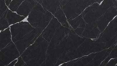The primary subject of the image is a black marble countertop. The setting is a kitchen, with the countertop being the main focus of the scene. The visual style is a close-up of the marble countertop, showcasing its texture and pattern. The colors and mood of the image are predominantly dark, with the black marble countertop being the main source of contrast.
