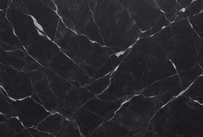 The primary subject of the image is a black marble countertop. The setting is a kitchen, with the countertop being the main focus of the scene. The visual style is a close-up of the marble countertop, showcasing its texture and pattern. The colors and mood of the image are predominantly dark, with the black marble countertop being the main source of contrast.