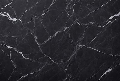 The primary subject of the image is a black marble countertop. The setting is a kitchen, with the countertop being the main focus of the scene. The visual style is a close-up of the marble countertop, showcasing its texture and pattern. The colors and mood of the image are predominantly dark, with the black marble countertop being the main source of contrast.