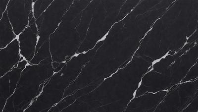 The primary subject of the image is a black marble countertop. The setting is a kitchen, with the countertop being the main focus of the scene. The visual style is a close-up of the marble countertop, showcasing its texture and pattern. The colors and mood of the image are predominantly dark, with the black marble providing a striking contrast against the dark background.