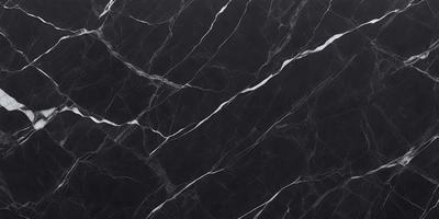 The primary subject of the image is a black marble countertop. The setting is a kitchen, with the countertop being the main focus of the scene. The visual style is a close-up of the marble countertop, showcasing its texture and pattern. The colors and mood of the image are predominantly dark, with the black marble countertop being the main source of contrast.