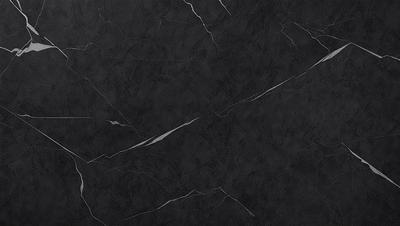 The primary subject of the image is a black marble countertop. The setting is a kitchen, with the countertop being the main focus of the scene. The visual style is a close-up of the marble countertop, showcasing its texture and details. The colors and mood of the image are predominantly dark, with the black marble countertop being the main source of contrast and visual interest.