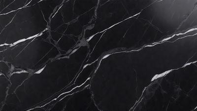 The primary subject of the image is a black marble countertop. The setting is a kitchen, with the countertop being the main focus of the scene. The visual style is a close-up of the marble countertop, showcasing its texture and pattern. The colors and mood of the image are predominantly black, giving it a sleek and modern appearance.