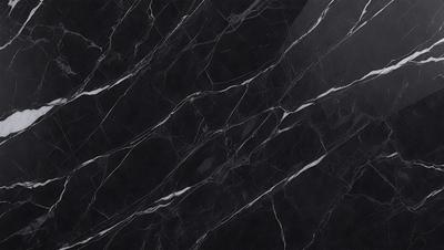 The primary subject of the image is a black marble countertop. The setting is a kitchen, with the countertop being the main focus of the scene. The visual style is a close-up of the marble countertop, showcasing its texture and pattern. The colors and mood of the image are predominantly dark, with the black marble countertop being the main source of contrast.