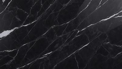 The primary subject of the image is a black marble countertop. The setting is a kitchen, with the countertop being the main focus of the scene. The visual style is a close-up of the marble countertop, showcasing its texture and pattern. The colors and mood of the image are predominantly dark, with the black marble countertop being the main source of contrast.