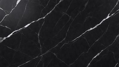 The primary subject of the image is a black marble countertop. The setting is a kitchen, with the countertop being the main focus of the scene. The visual style is a close-up of the marble countertop, showcasing its texture and pattern. The colors and mood of the image are predominantly dark, with the black marble countertop being the main source of contrast.