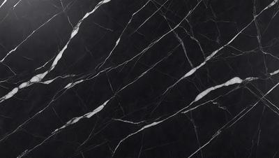 The primary subject of the image is a black marble countertop. The setting is a kitchen, with the countertop being the main focus of the scene. The visual style is a close-up of the marble countertop, showcasing its texture and pattern. The colors and mood of the image are predominantly dark, with the black marble countertop being the main source of contrast.