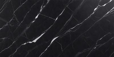 The primary subject of the image is a black marble countertop. The setting is a kitchen, with the countertop being the main focus of the scene. The visual style is a close-up of the marble countertop, showcasing its texture and pattern. The colors and mood of the image are predominantly dark, with the black marble providing a striking contrast against the surrounding environment.