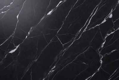 The primary subject of the image is a black marble countertop. The setting is a kitchen, with the countertop being the main focus of the scene. The visual style is a close-up of the marble countertop, showcasing its texture and pattern. The colors and mood of the image are predominantly dark, with the black marble countertop being the main source of contrast.