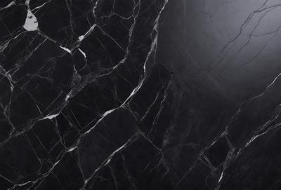 The primary subject of the image is a black marble countertop. The setting is a kitchen, with the countertop being the main focus of the scene. The visual style is a close-up of the marble countertop, showcasing its texture and pattern. The colors and mood of the image are predominantly dark, with the black marble countertop being the main source of contrast.