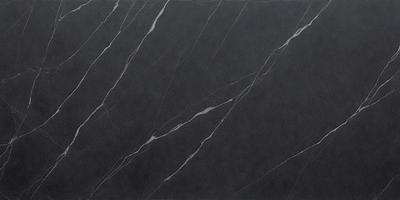 The primary subject of the image is a black marble countertop. The setting is a kitchen, with the countertop being the main focus of the scene. The visual style is a close-up of the marble countertop, showcasing its texture and pattern. The colors and mood of the image are dark and moody, with the black marble countertop being the dominant color.