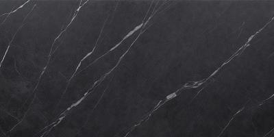 The primary subject of the image is a black marble countertop. The setting is a kitchen, with the countertop being the main focus of the scene. The visual style is a close-up of the marble countertop, showcasing its texture and pattern. The colors and mood of the image are predominantly dark, with the black marble countertop being the main source of contrast.