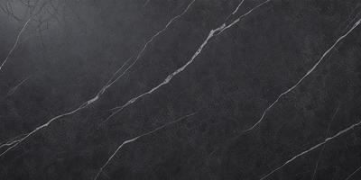 The primary subject of the image is a close-up of a marble countertop. The setting is a kitchen, with the countertop being the main focus of the scene. The visual style is a photo, capturing the natural texture and beauty of the marble surface. The colors and mood of the image are predominantly black and white, giving it a classic and elegant appearance.