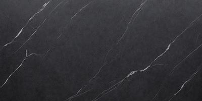 The primary subject of the image is a gray marble countertop. The setting is a kitchen, with the countertop being the main focus of the scene. The visual style is a photo, capturing the natural texture and appearance of the marble countertop. The colors and mood of the image are predominantly gray, giving it a sleek and modern appearance.