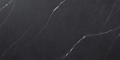 The primary subject of the image is a marble countertop with a black background. The countertop appears to be made of marble, and it has a black color. The visual style of the image is a close-up of the marble countertop, showcasing its texture and details. The colors and mood of the image are dark and moody, with the black marble countertop being the main focus.