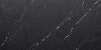 The primary subject of the image is a black marble countertop. The setting is a kitchen, with the countertop being the main focus of the scene. The visual style is a close-up of the marble countertop, showcasing its texture and appearance. The colors and mood of the image are predominantly dark, with the black marble countertop being the main source of contrast and visual interest.