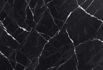 The primary subject of the image is a black marble countertop. The setting is a kitchen, with the countertop being the main focus of the scene. The visual style is a close-up of the marble countertop, showcasing its texture and pattern. The colors and mood of the image are predominantly dark, with the black marble countertop being the main source of contrast.