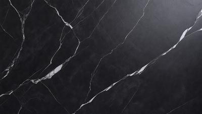 The primary subject of the image is a black marble countertop with a white vein running through it. The setting is a kitchen, and the visual style is a close-up of the countertop. The colors and mood of the image are predominantly black and white, giving it a sleek and modern appearance.