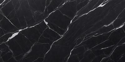 The primary subject of the image is a black marble countertop. The setting is a kitchen, with the countertop being the main focus of the scene. The visual style is a close-up of the marble countertop, showcasing its texture and pattern. The colors and mood of the image are predominantly dark, with the black marble providing a striking contrast against the darker background.