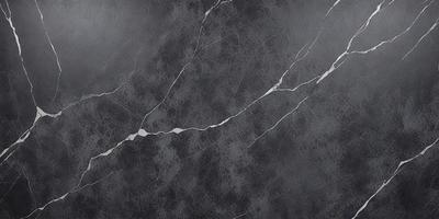 The primary subject of the image is a marble wall with a patterned texture. The setting is a room with a grey marble wall as the main focus. The visual style is a close-up of the marble wall, showcasing its unique texture and pattern. The colors and mood of the image are predominantly grey, giving it a sophisticated and elegant appearance.