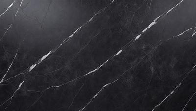 The primary subject of the image is a black marble countertop. The setting is a kitchen, with the countertop being the main focus of the scene. The visual style is a close-up of the marble countertop, showcasing its texture and details. The colors and mood of the image are predominantly dark, with the black marble countertop being the main source of contrast and visual interest.