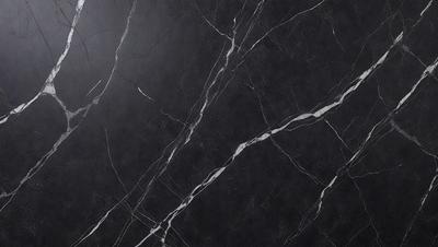 The primary subject of the image is a black marble countertop. The setting is a kitchen, with the countertop being the main focus of the scene. The visual style is a close-up of the marble countertop, showcasing its texture and pattern. The colors and mood of the image are predominantly dark, with the black marble countertop being the main source of contrast.