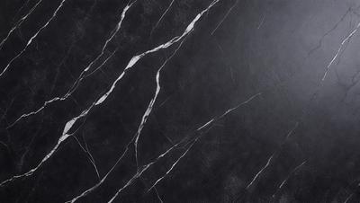 The primary subject of the image is a black marble countertop. The setting is a kitchen, with the countertop being the main focus of the scene. The visual style is a close-up of the marble countertop, showcasing its texture and details. The colors and mood of the image are dark and moody, with the black marble countertop being the dominant color.