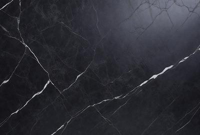 The primary subject of the image is a close-up of a black marble wall. The setting is a dark room, and the visual style is a photo. The dominant colors are black and white, creating a moody atmosphere.