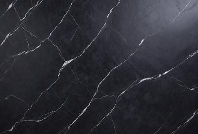 The primary subject of the image is a black marble countertop with a patterned texture. The setting is a kitchen or bathroom, as the countertop is a part of the design. The visual style is a close-up of the marble countertop, showcasing its unique texture and pattern. The colors and mood of the image are dark and moody, with the black marble providing a dramatic and elegant appearance.