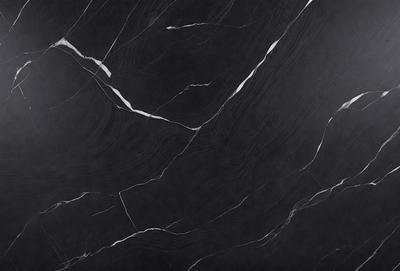 The primary subject of the image is a black marble countertop with a white vein running through it. The setting is a kitchen, and the visual style is a close-up of the marble countertop. The colors and mood of the image are predominantly black and white, giving it a sleek and modern appearance.