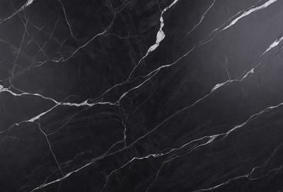 The primary subject of the image is a black marble countertop. The setting is a kitchen, with the countertop being the main focus of the scene. The visual style is a close-up of the marble countertop, showcasing its texture and pattern. The colors and mood of the image are predominantly dark, with the black marble countertop being the main source of contrast.