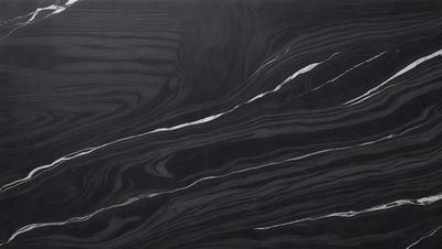 The primary subject of the image is a black marble countertop with a patterned design. The setting is a kitchen, and the visual style is a close-up of the marble countertop. The colors and mood of the image are dark and dramatic, with the black marble providing a striking contrast against the surrounding environment.