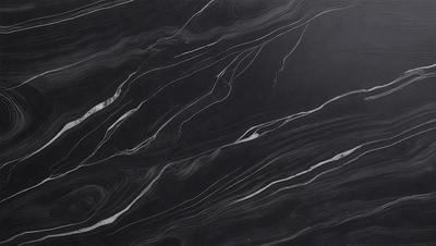 The primary subject of the image is a black marble countertop. The setting is a kitchen, with the countertop being the main focus of the scene. The visual style is a close-up of the marble countertop, showcasing its texture and pattern. The colors and mood of the image are predominantly dark, with the black marble countertop being the main source of contrast.