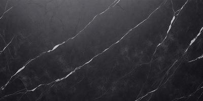 The primary subject of the image is a marble countertop with a black background. The countertop appears to be a dark grey color, giving it a sleek and modern look. The visual style of the image is a close-up of the marble countertop, showcasing its texture and details. The colors and mood of the image are predominantly dark, with the marble countertop being the main focus and the black background providing a sense of sophistication and elegance.
