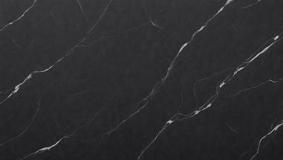 The primary subject of the image is a black marble countertop. The setting is a kitchen, with the countertop being the main focus of the scene. The visual style is a close-up of the marble countertop, showcasing its texture and pattern. The colors and mood of the image are predominantly dark, with the black marble countertop being the main source of contrast and visual interest.