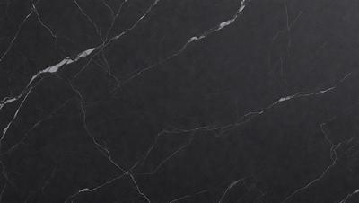 The primary subject of the image is a black marble countertop. The setting is a kitchen, with the countertop being the main focus of the scene. The visual style is a close-up of the marble countertop, showcasing its texture and appearance. The colors and mood of the image are predominantly black, giving it a sleek and modern look.