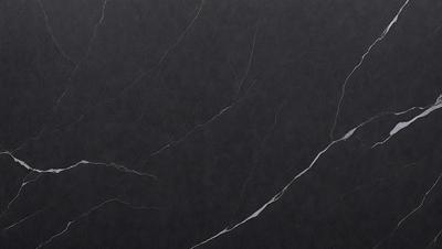 The primary subject of the image is a black marble countertop. The setting is a kitchen, with the countertop being the main focus of the scene. The visual style is a close-up of the marble countertop, showcasing its texture and details. The colors and mood of the image are predominantly dark, with the black marble countertop being the main source of contrast and visual interest.