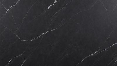 The primary subject of the image is a black marble countertop. The setting is a kitchen, with the countertop being the main focus of the scene. The visual style is a close-up of the marble countertop, showcasing its texture and details. The colors and mood of the image are predominantly dark, with the black marble countertop being the main source of contrast and visual interest.