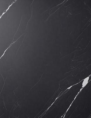 The primary subject of the image is a black marble countertop. The setting is a kitchen, with the countertop being the main focus of the scene. The visual style is a photo, capturing the countertop's texture and appearance. The colors in the image are predominantly black, giving the countertop a sleek and modern look. The overall atmosphere is elegant and sophisticated, reflecting the high-quality material and design of the marble countertop.