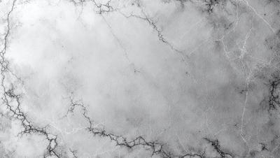 The image features a large, white marble wall with a textured surface. The wall appears to be a part of a building, possibly a museum or an art gallery. The primary subject of the image is the marble wall, which is the main focus of the scene. The setting is indoors, and the visual style is a close-up of the marble wall, showcasing its unique texture and appearance. The colors in the image are predominantly white, giving the wall a clean and elegant appearance.